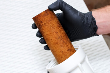 The plumber is changing the replaceable dirty used aqua filter. Replaceable dirty filters for...