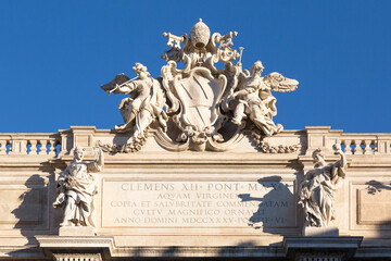 18th century Trevi Fountain, papal coat of arm at the top of the building, Rome, Italy