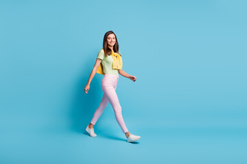 Fototapeta na wymiar Full length body size view of attractive cheerful girl wearing casual look strolling pastime isolated over bright blue color background