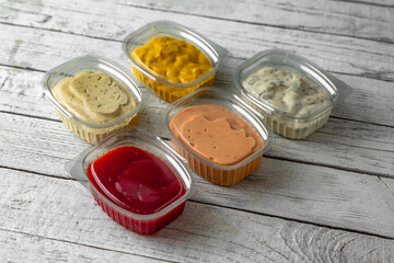 Assorted different sauces in plastic packaging