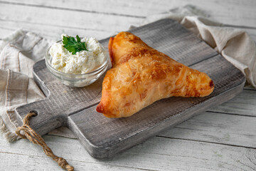 Placinda pie stuffed with cottage cheese and herbs. Rich pastries.