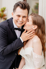 beautiful, gentle and happy bride and groom. man gently touches woman's face