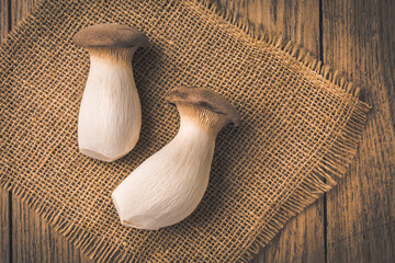 King oyster mushrooms on the wooden background © Brebca