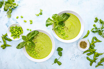 Pureed edamame soup with fresh herbs seasoning, top down view