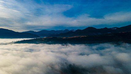 mountains tops high above clouds fog