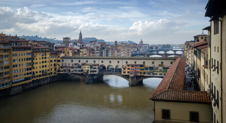 Ponte Vecchio bridge and River Arno in Florence, Tuscany, Italy at day from Ponte alle Grazie  (Firenze). A medieval stone closed-spandrel segmental arch bridge