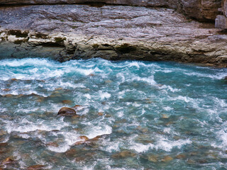 wild blue water of Aare river and stony river bank in Bernese Oberland, Switzerland