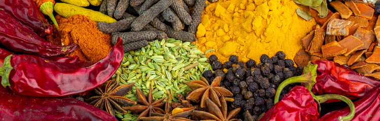 Various spices, peppers and herbs close-up top view. Eastern spice market. A set of peppers and...