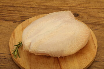 Raw whole chicken breast with skin
