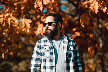 Single man outside in sunglasses plaid clothing autumn fall