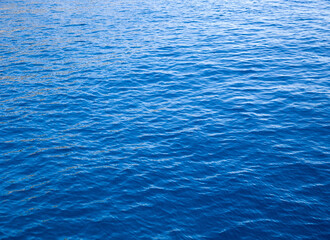 Blue water with sun reflections