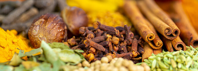 Various spices, peppers and herbs close-up top view. Eastern spice market. A set of peppers and spices for cooking.