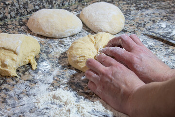 Making dough by hands.Making buns at home. The process of kneading wheat buns. Hands of the woman.buns