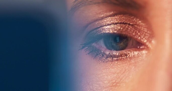 Eye extreme macro. Extreme close up shot of the woman's eye with make up and with smart phone reflection. Woman surfs the internet