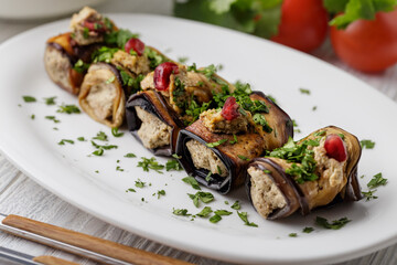 Aubergine rolls with nuts, cilantro, pomegranate