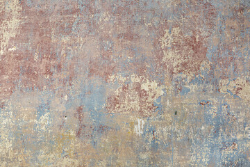 background of old wall with removed tapestry gives a look in paint of different ages