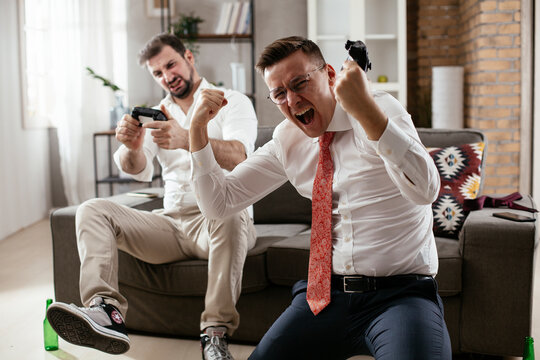 Businessmen Playing Video Games In The Office. Colleagues Relaxing After Meeting..