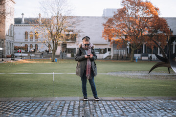 Girl on phone in trinity college dublin