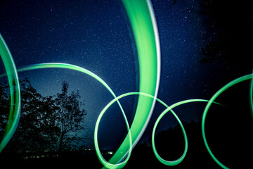 Bright neon lights under night sky strewn with stars