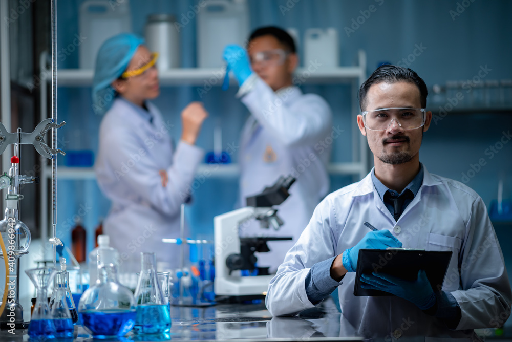 Wall mural scientists are recording data and analyzing laboratory study results.