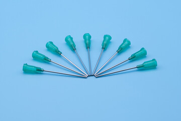 Hollow blunt needles for syringes isolated against a blue background