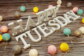 Happy Tuesday alphabet letter with LED cotton balls on wooden background
