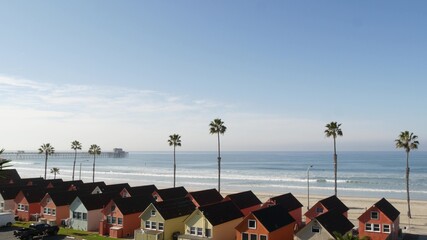 Colorful waterfront cottages in Oceanside, California USA. Multicolor bungalow huts by sea,...