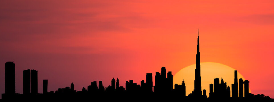 Stunning view of the silhouette of the Dubai skyline during a beautiful and dramatic sunset. Photorealistic image of the Dubai Cityscape.