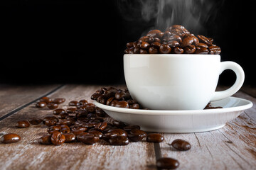 Hot roasted coffee beans in a white coffee cup