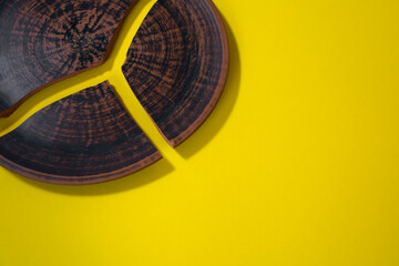 Broken clay plate with a beautiful pattern on a yellow background. Free space for text. The pottery...