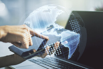 Digital America map and finger presses on a digital tablet on background, global technology concept. Multiexposure