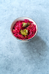 Fototapeta na wymiar Beetroot Pad Thai Rice Noodles with Beet Flavored and Broccoli in Bowl.
