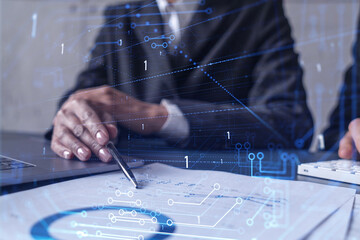 Two research and development specialists man and woman working on project to create a new approach to develop software to improve business. Technological icons over the table with document.