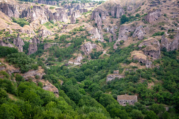 Fototapeta na wymiar Old Khndzoresk, Armenia - July 7, 2018: The caves of Khndzoresk old town near Goris in Armenia