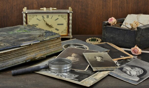  Old photo album and historical photos of family on wooden background,

