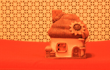 Clay house with thatched roof in Ukrainian traditional style. blooming sunflower