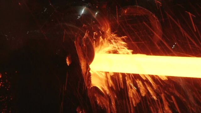 red hot metal bars in continuous casting machine at metallurgical plant