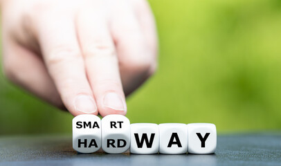 Hand turns dice and changes the expression "hard way" to "smart way".