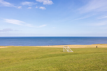 Mini goalposts soccer / football field summer day by the sea