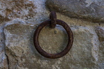 evocative texture image of ancient ring to tie horses to the wall 