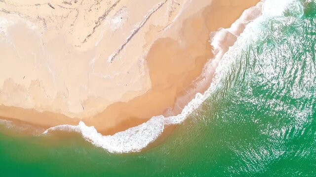 Aerial view top down drone video High Quality of Beautiful tropical beach with white wave crashing on sandy shore Beautiful Phuket beach is famous tourist destination at Andaman sea Travel and tour