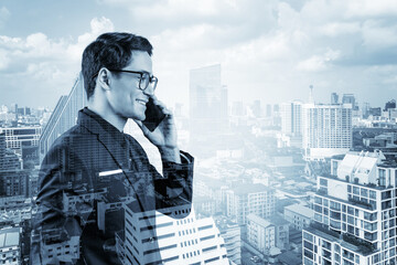 Prosperous handsome entrepreneur in suit and glasses pensively talking phone and looking on Bangkok cityscape. The concept of problem solving consulting. Downtown view. Double exposure.