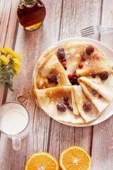 
Homemade pancakes, delicious thin pancakes with berries and maple syrup
