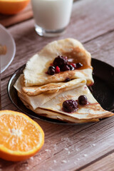 
Homemade pancakes, delicious thin pancakes with berries and maple syrup