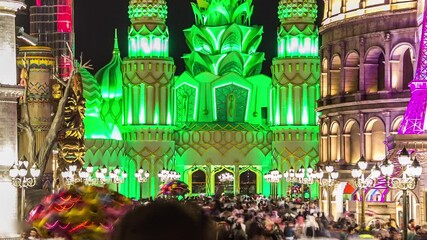 Colorful Entrance to Global Village with crowd timelapse in Dubai, UAE. Brightly colouredl lights and highly detailed pavilion facades have helped make Global Village one of Dubai's most popular