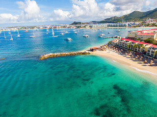 The caribbean island of St.Maarten landscape and Citiscape. Pelican beach  located in the Caribbean island of St Maarten.  - obrazy, fototapety, plakaty