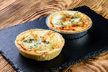 Tartlet pastries. Delicious and healthy range of bakery. hearty tartlets. baked tart pies with cheese, meat, mushroom and dill for sale. Food, gastronomy and pastry concept