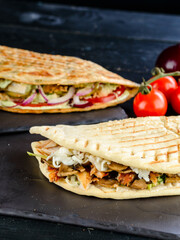 Snack. Takeaway food, street fast food. Pita bread sandwich with fresh vegetables and meat. Kebab in flat cake