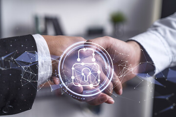 Handshake of two businesspeople who are negotiated the project to protect cyber security of...