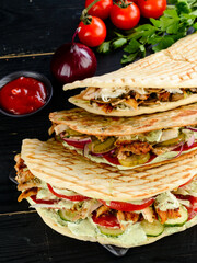 Snack. Takeaway food, street fast food. Pita bread sandwich with fresh vegetables and meat. Kebab in flat cake